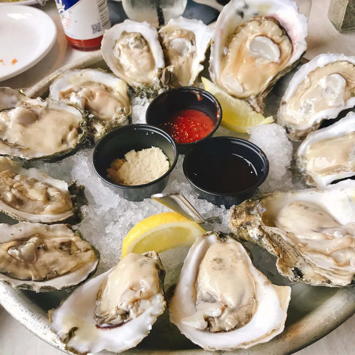 Raw oysters on ice with cocktail sauce